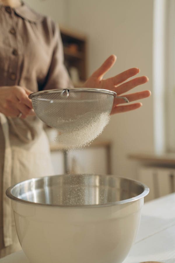 Sifting into stainless steel mixing bowl