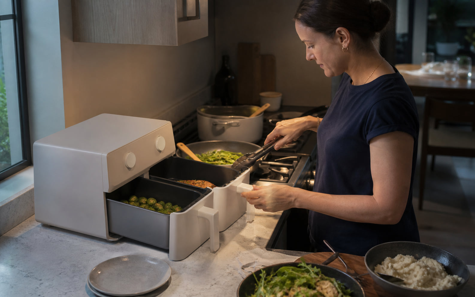 Editorial scene showing separate meal components, dual controls, and multiple hot food-contact parts.