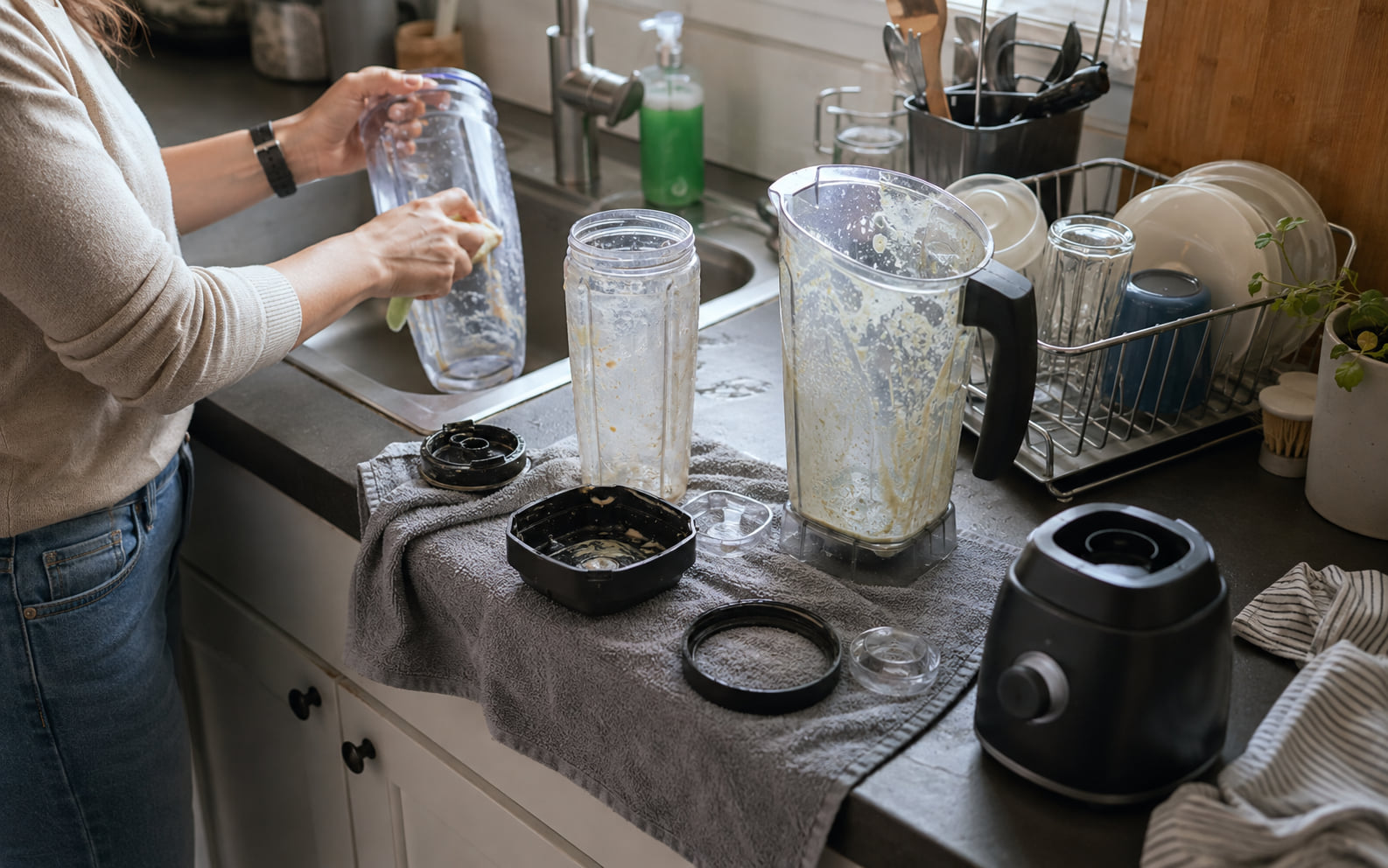 Editorial scene showing a believable blender pitcher, lid, cup, and food-contact parts drying after infrequent use on a finite counter.